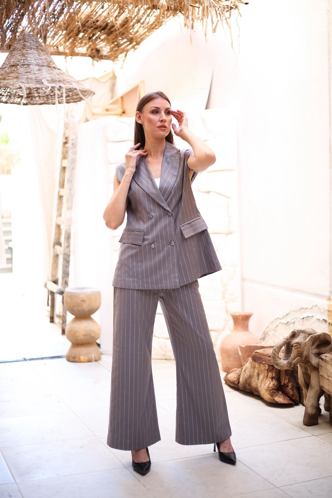 Practical pantsuit with a light gray vest and white striped trim
