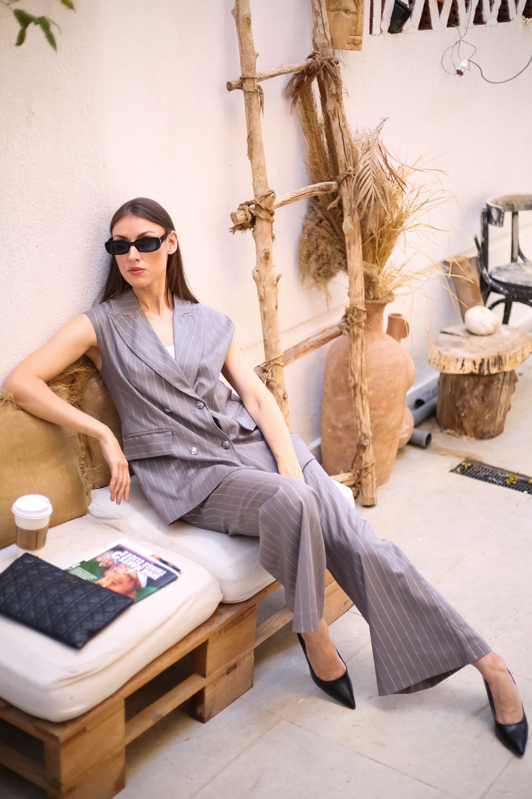 Practical pantsuit with a light gray vest and white striped trim