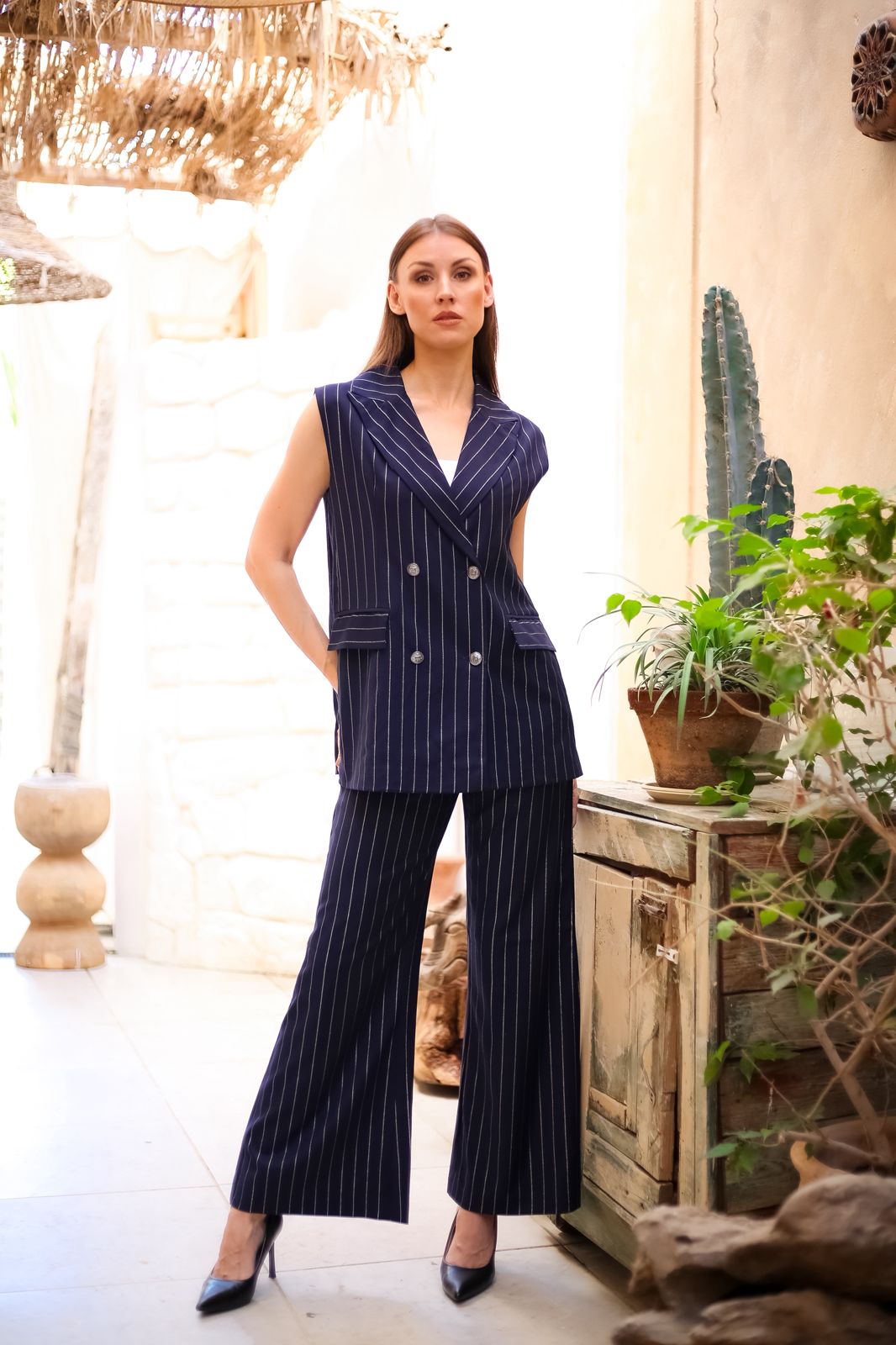 Practical pantsuit with a navy blue vest and white striped trim