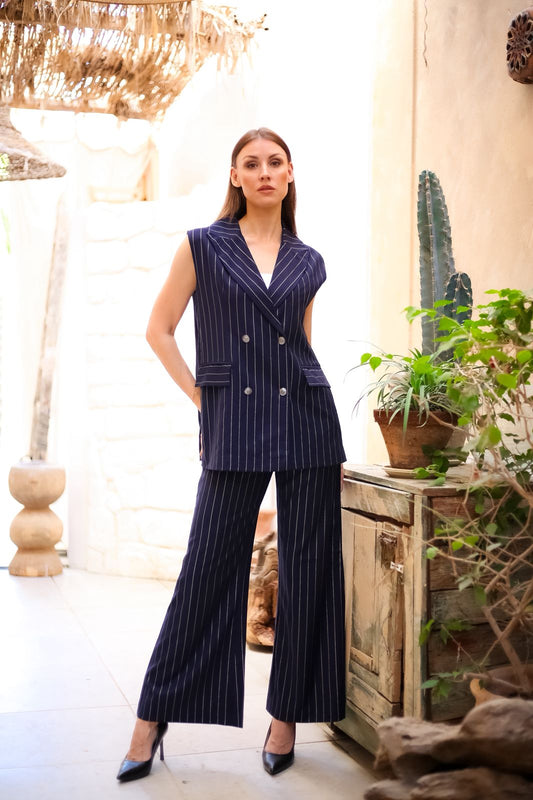 Practical pantsuit with a navy blue vest and white striped trim